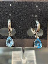 Load image into Gallery viewer, Sterling silver pear shaped blue topaz dangle hoop earrings