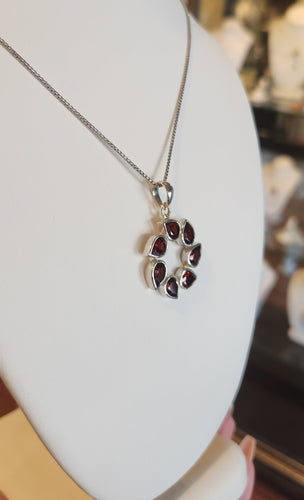 Sterling silver pear-shaped garnet circle pendant